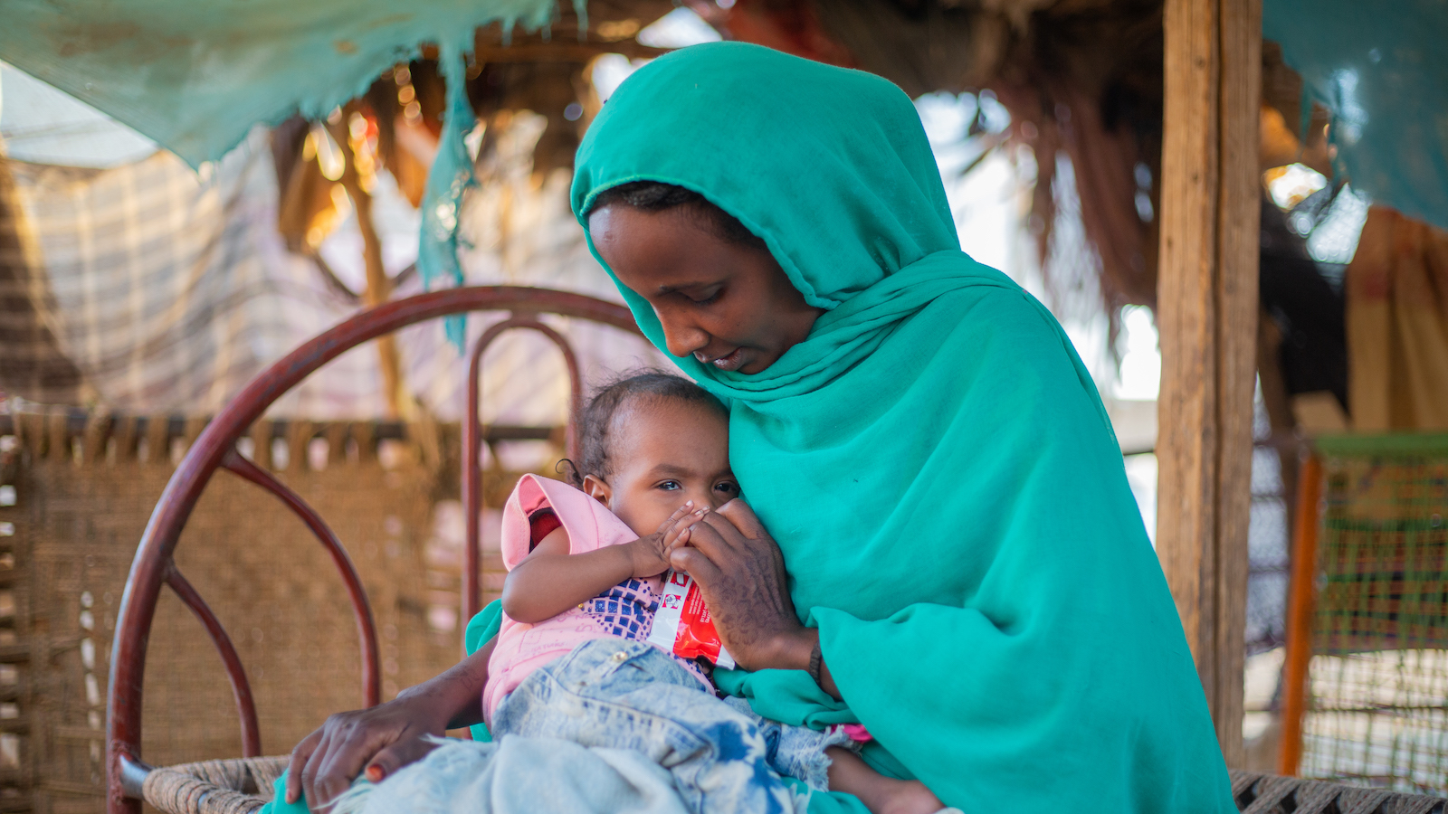 Malaz feeds her two-year-old Aida ready-to-use-therapeutic food at her home in Kassala State. During the mass mid-upper arm circumference (MUAC) screening and referral for children under five, Aida was confirmed severely malnourished. She was very weak and immediately referred to Al-Arab health facility for treatment. (Photo: Ahmed Elfatih Mohamdeen/UNICEF)