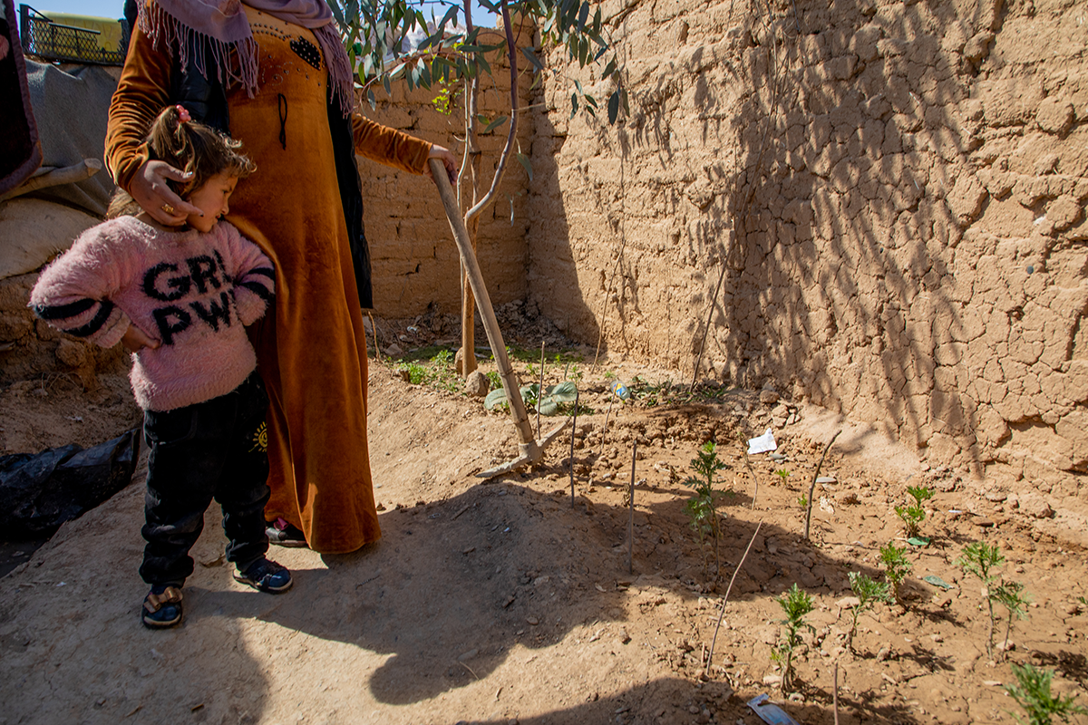 Shahama*, along with one of her daughters, shows us her garden. (Photo: Gavin Douglas/Concern Worldwide)