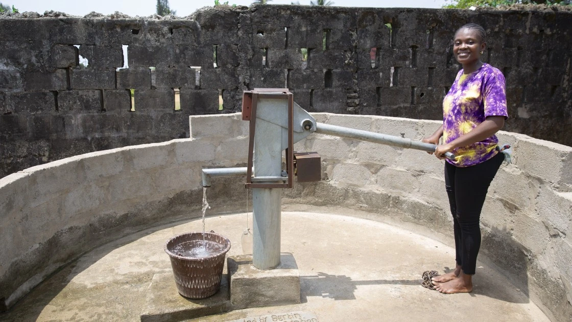 Patience Jackson of the local WASH committee at a newly constructed water point in Joe Quarter, Buchanan, Liberia. The construction and rehabilitation of wells across multiple urban communities around Buchanan has been supported by the Bertin Family Foundation. (Photo: Kieran McConville/Concern Worldwide)