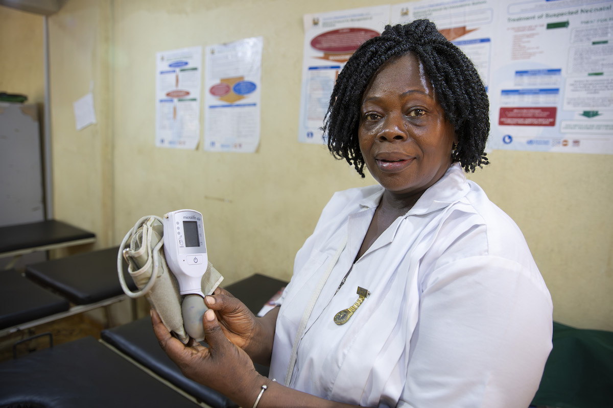 Glynis Wusi, a Senior Midwife in the Concern-supported health center at Mathoir, Tonkolili, Sierra Leone, holds a CRADLE vital signs alert device. Photos: Kieran McConville/Concern Worldwide