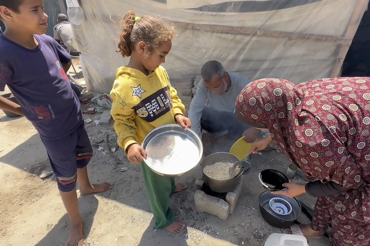 Hassan* (48) and Mariam* (34) prepare dinner for their family of seven in Rafah. They have been displaced more than five times and struggle with getting enough food via aid distributions. (Photo: Concern Worldwide)