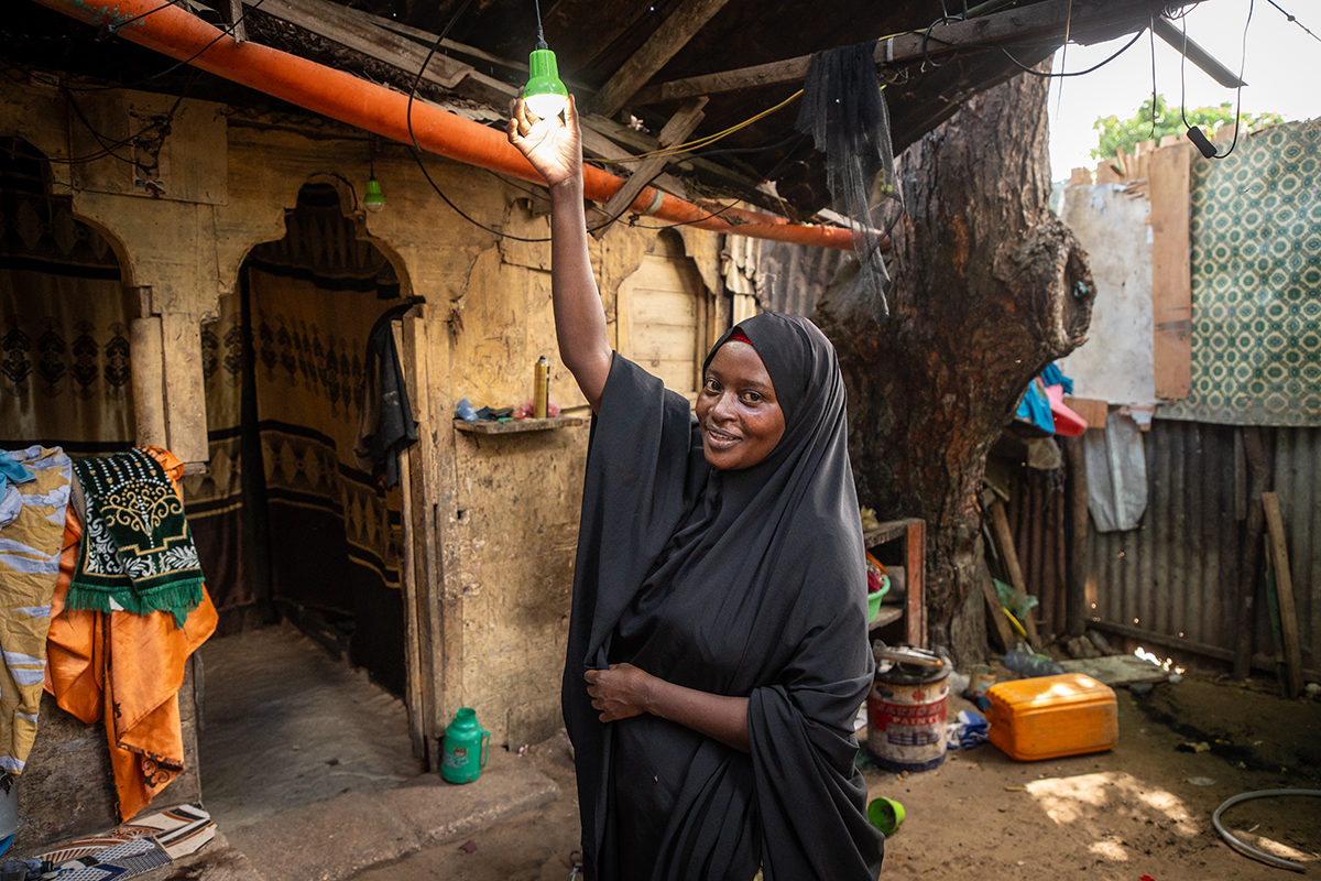 Idil* turning on the solar light she received as part of the Green Graduation program by Concern. (Photo: Mustafa Saeed/Concern Worldwide)