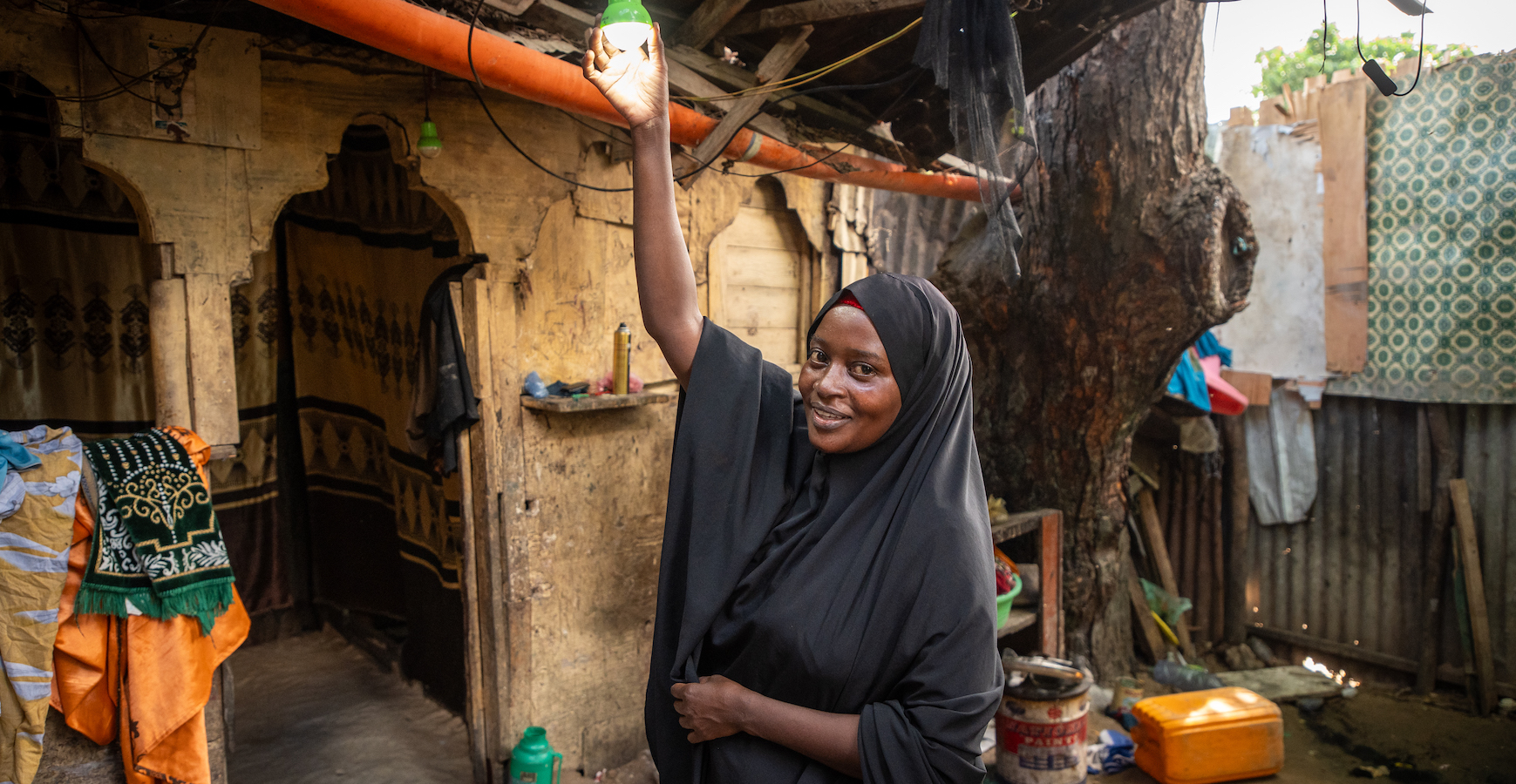 Idil* turning on the solar light she received as part of the Green graduation programme by Concern. (Photo: Mustafa Saeed/Concern Worldwide)