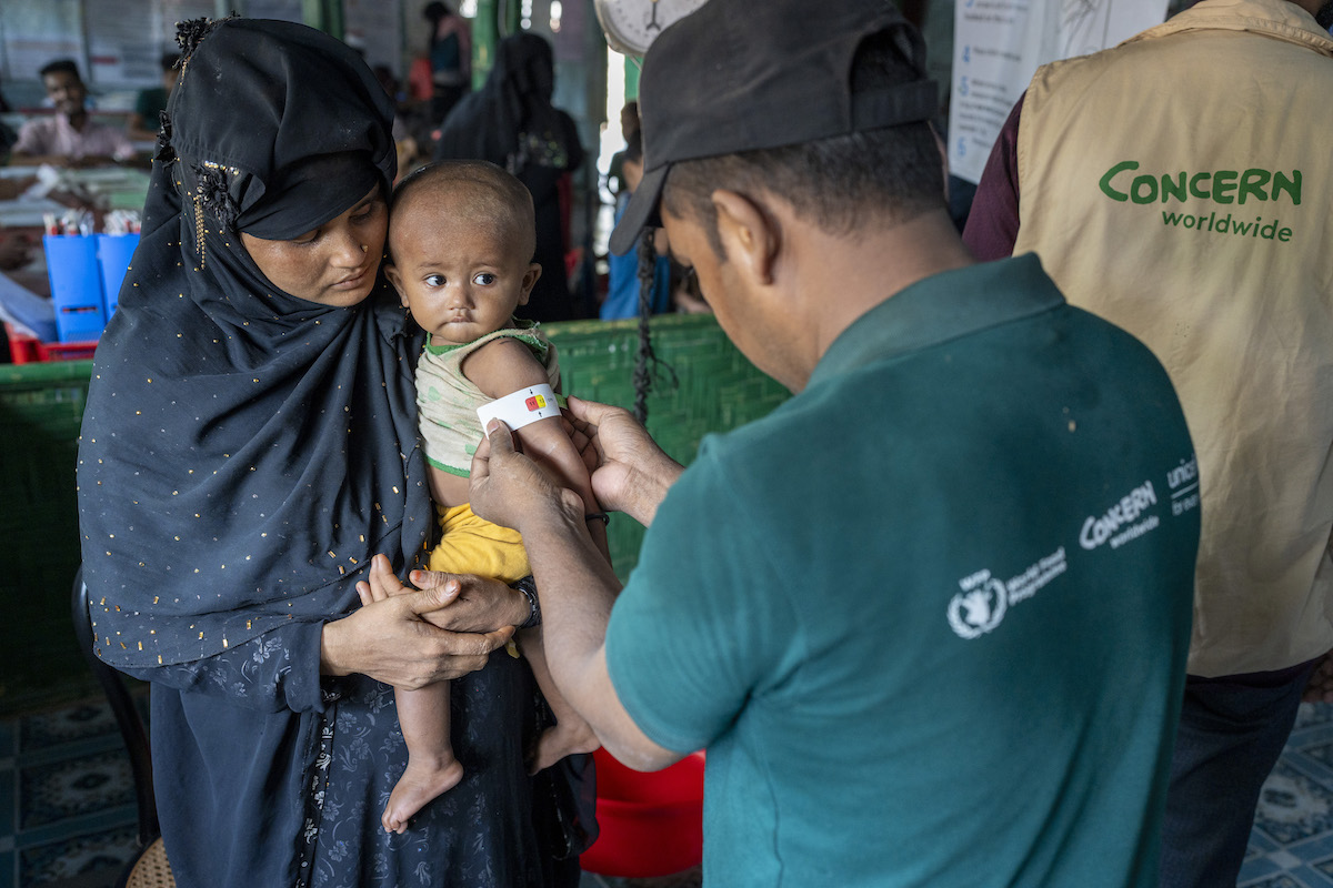 Ayesha* (25) a Rohingya mother visits the Concern nutrition center in Camp 13, Cox's Bazar, with her son Anwar* (9 months). Anwar has malnutrition and is being monitored. His mid-upper arm circumference (MUAC) is measured as part of this. Malnutrition is often diagnosed in children by measuring the MUAC as their bodies will use muscle and fat for fuel if a child doesn't have enough food. (Photo: Saikat Mojumder/Concern Worldwide)