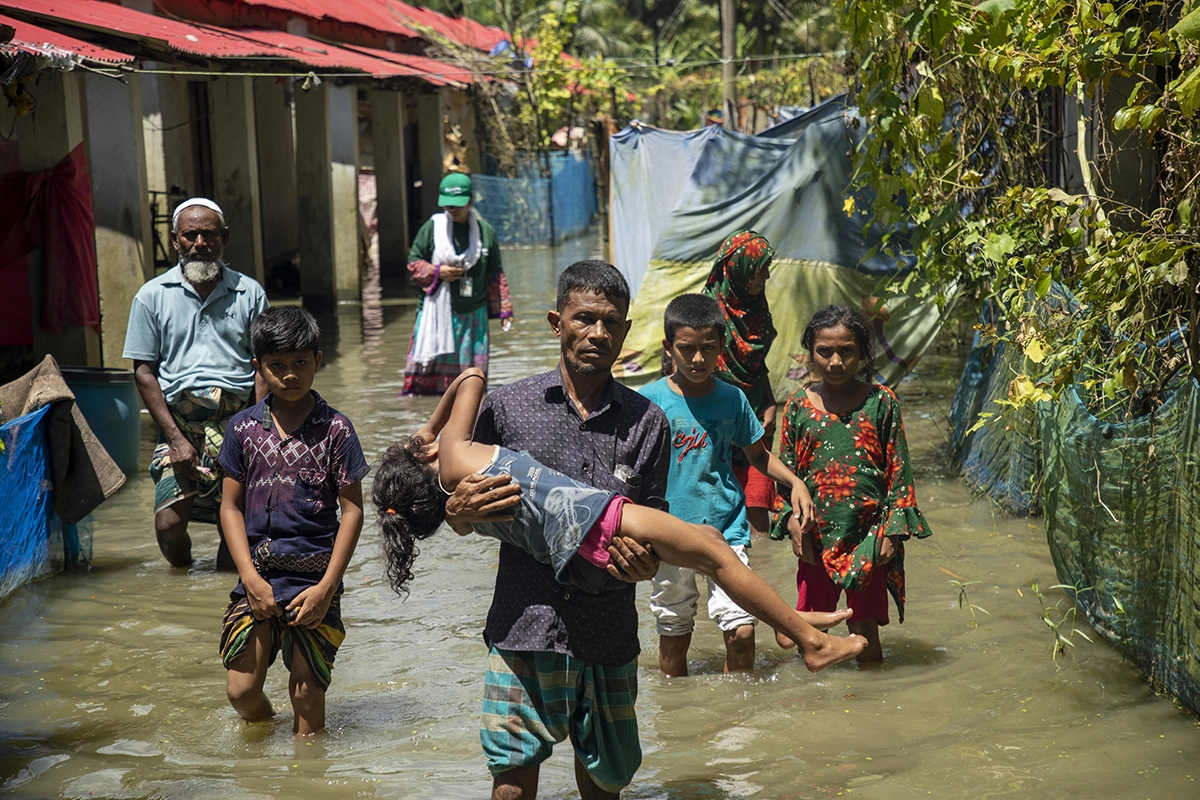 Residents of Noakhali district, Bangladesh, make their way through flooded streets, August 2024. (Photo: Akram Hossain/Concern Worldwide)