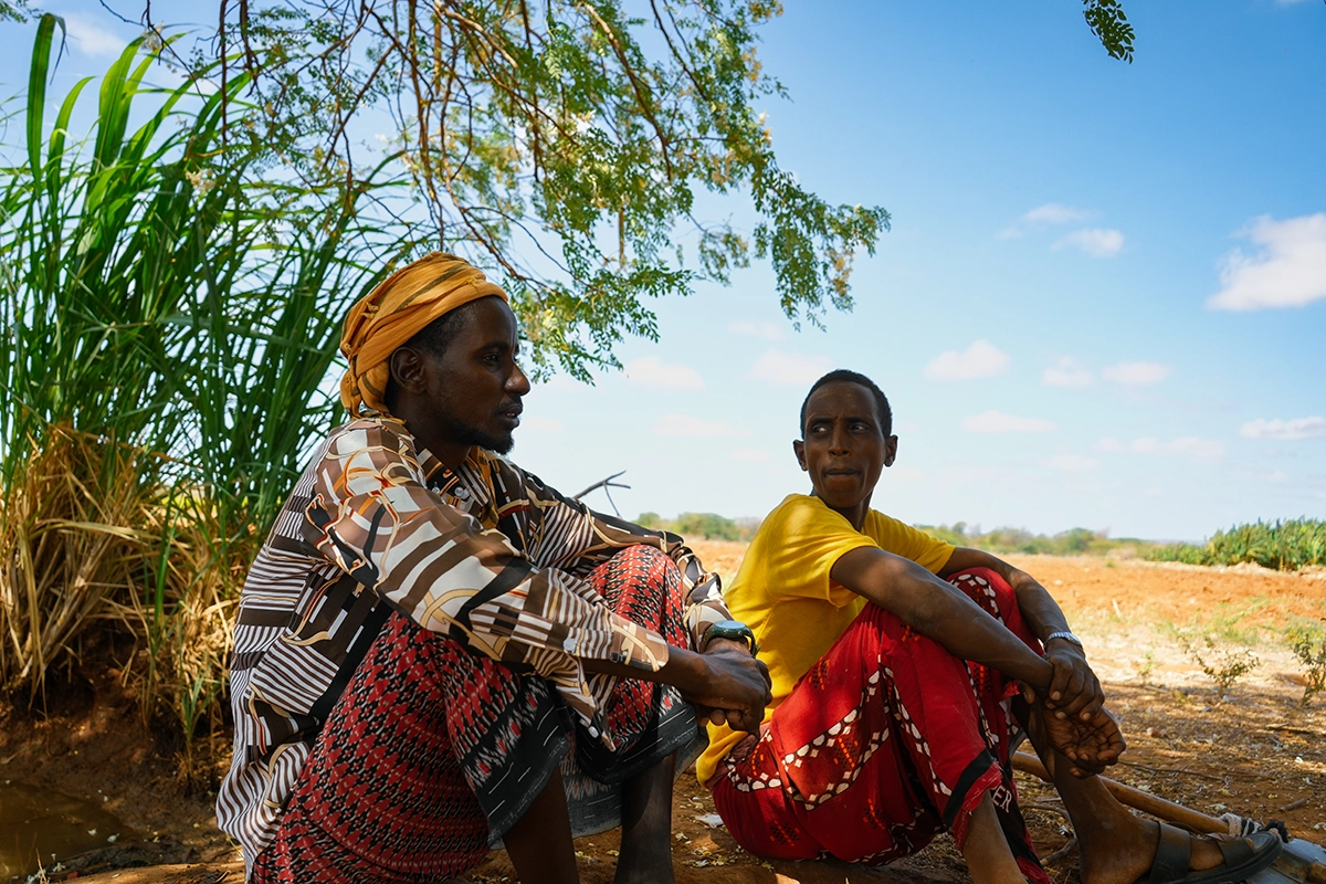 Hassan Ali and Adam Mohamed take a break from working their fields in Bardhere District. (Photo: Concern Worldwide)