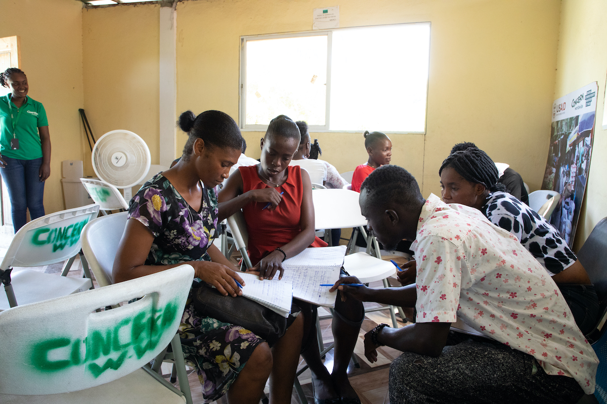 Winnie* (left) attends a Manje Pi Byen business training course, where vendors learn topics like building a business plan, investment, and entrepreneurship. (Photo: Jon Hozier-Byrne/Concern Worldwide)