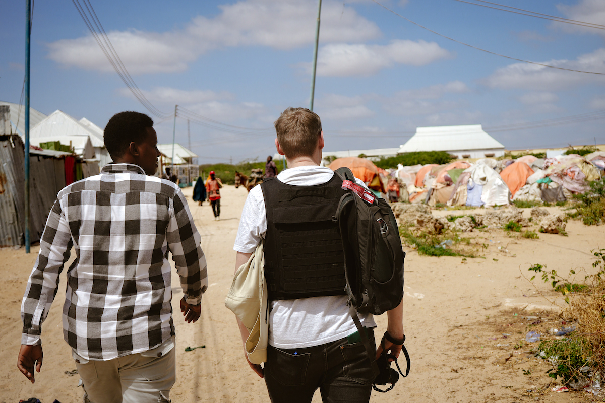 Concern Donor Visibility Officer Hugh Golden (right) visits a displacement site near Mogadishu. Photo: Adnan Mohamed/Concern Worldwide