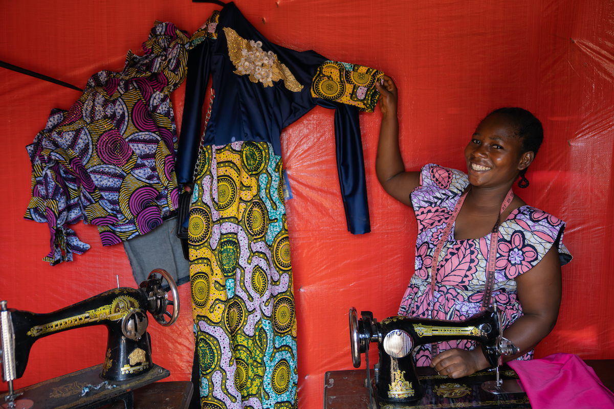 Alice at the shop she was able to start in part through her participation in a Concern-led VSLA. With a loan from her VSLA, she began to sell fabric, and she's also teaching others to sew so they can start their own shops. (Photos: Eugene Ikua/Concern Worldwide)