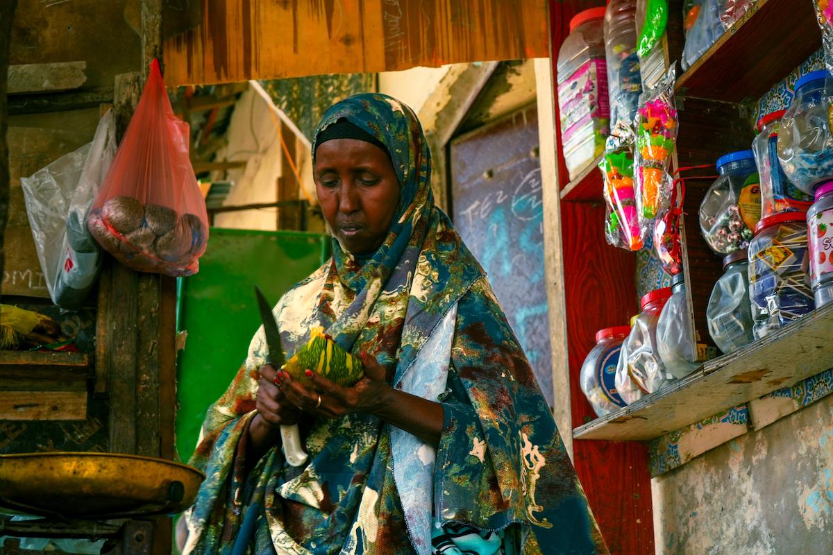 Mako slices melon to sell in her shop. (Photo: Adnan Mohamed/Concern Worldwide)