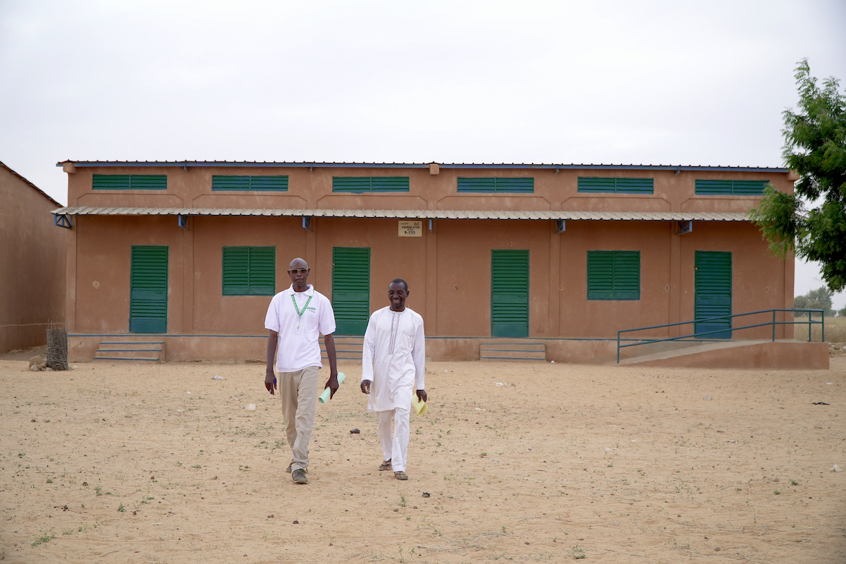 Ibrahim* with a Concern Niger staff member walk through a series of classrooms refurbished by Concern as part of the Learning Together program. (Photo: Concern Worldwide)