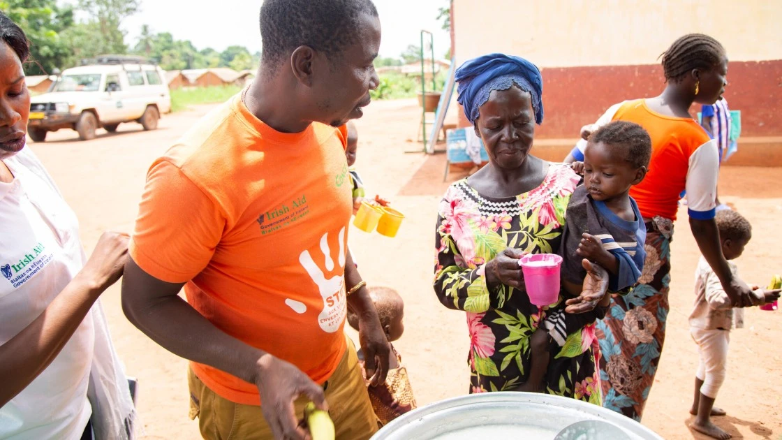 Dominique* feeds her orphaned grandchild Sylvie*, as part of a nutrition programme organized in Central African Republic by Concern Worldwide. Photo: Mussa Uwitonze/Arete/Concern Worldwide