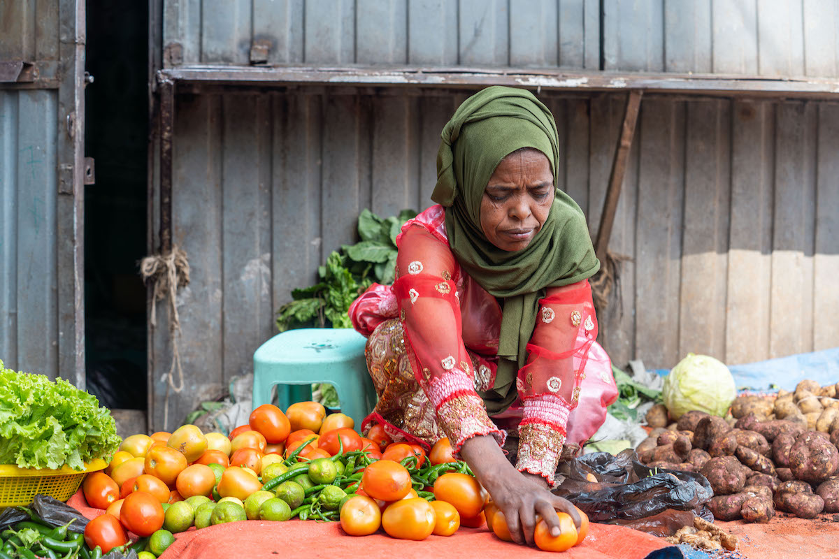 Birhani Kamal (50) at her grocery store in Woreda 09 in Addis Ababa. Birhane got the chance to join Concern’s KOICA-funded project, Improving Livelihoods for Urban Poor. She attended the training and learned how to keep track of her money, how to grow her small business, and how to plan. With the support she received, she was able to expand her market. Before the training she just sold what she could and spent whatever she earned. Now she knows exactly how much money comes in and how much goes out. Her stall now has more vegetables, more variety, and more customers. (Photo: Eugene Ikua/Concern Worldwide)