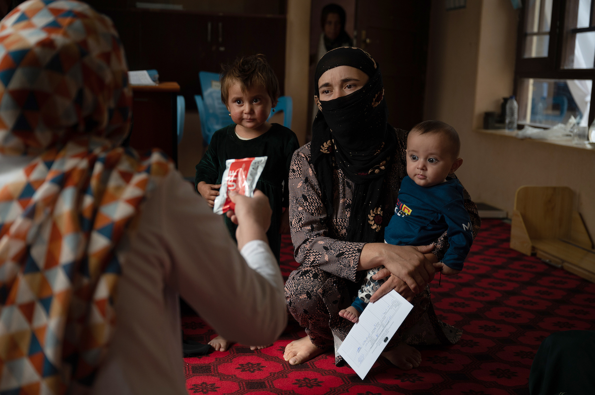 Tahira* receives therapeutic food for her seven-month-old son Faris*'s malnutrition. Faris has been treated at a Concern-supported Family Health House. Photo: Nava Jamshidi/Concern Worldwide