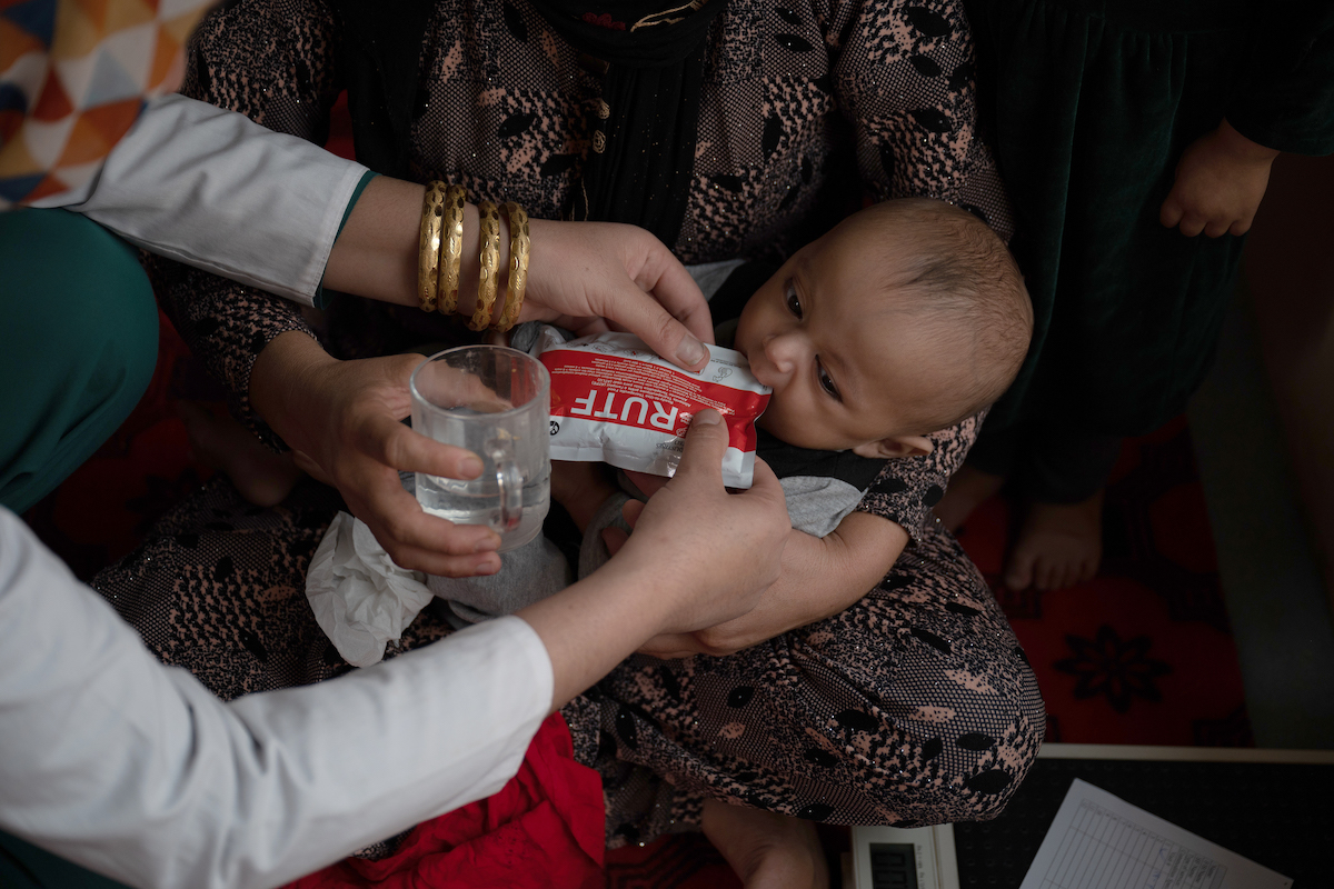 A Family Health House midwife in Takhar Province feeds Tahira*'s infant son, Faris*, ready-to-use therapeutic food (RUTF) as part of his treatment for malnutrition. (Photo: Nava Jamshidi/Concern Worldwide)