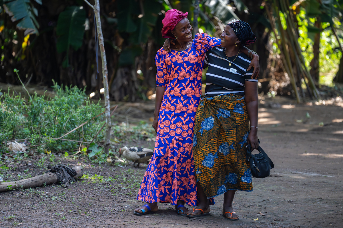 Rugiatu Kamara with her friend and fellow small-scale farmer Aminata Bangura. Aminata also participated in Yoti Yoti, which has helped her in raising her four children since the death of her husband. She adds that her farmers' group offers a safe space for mothers to spend time together, share their challenges, and support one another. (Photo: Eugene Ikua/Concern Worldwide)