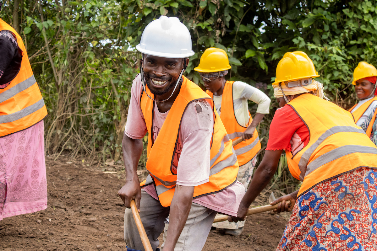 Antoine-Roger* contributes to community works aimed at improving local infrastructure while supporting vulnerable households in Beni, North Kivu.