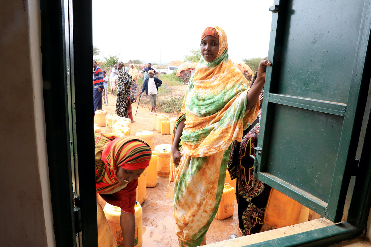 Hanaano program participant Adnan waits to collect water at a community water point in Kenya's Mandera region.