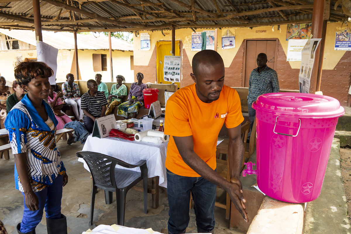 A handwashing demonstration using a “veronica bucket” at Lumpa Health Center, near Freetown in Sierra Leone in 2014. (Photo: Kieran McConville/Concern Worldwide)