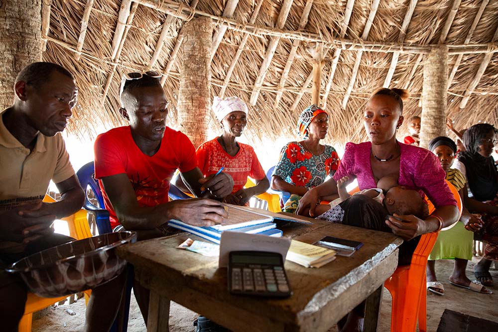 Chairman, Yusuf Mansaray, at a VSLA meeting at Magborkor in Sierra Leone. (Photo: Kieran McConville/Concern Worldwide)