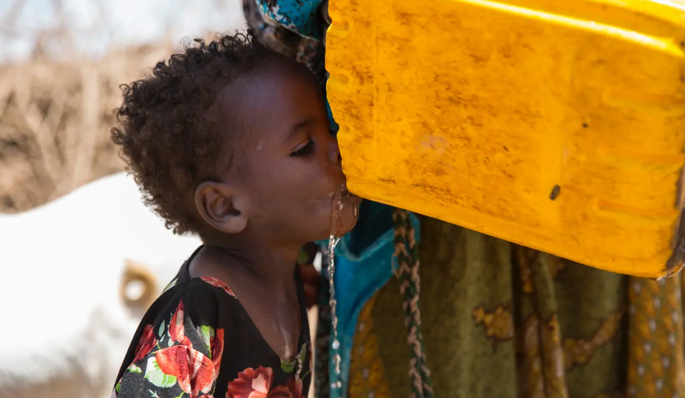 A young girl drinks water in Somaliland