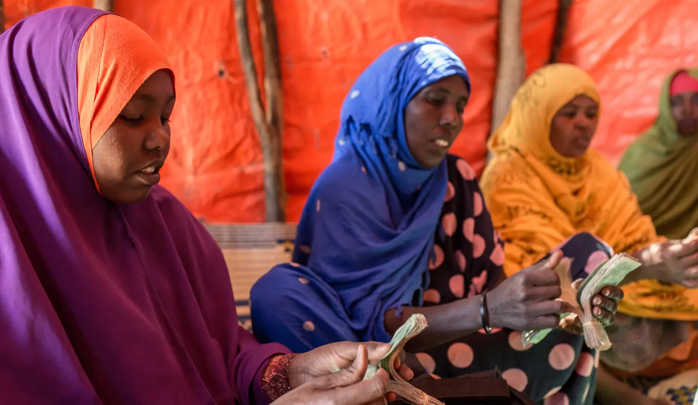 Women in a Somali village joined a committee to learn how to survive hardships such as drought and support each other through a Village Savings and Loans Association