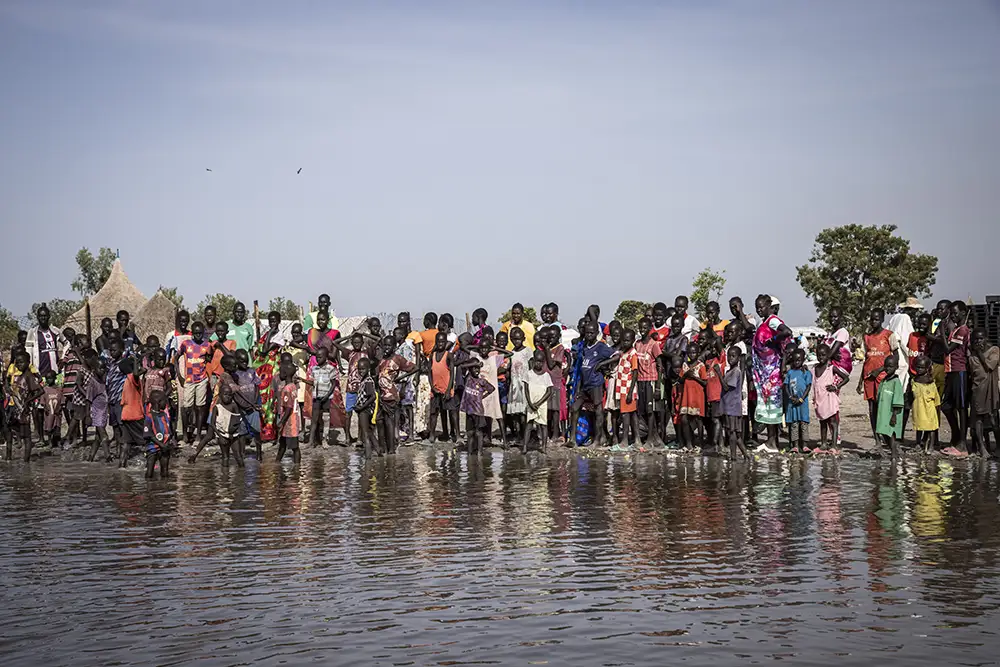 People wait for an emergency cash distribution following a devastating flood in Unity State. (Photo: Ed Ram/Concern Worldwide)