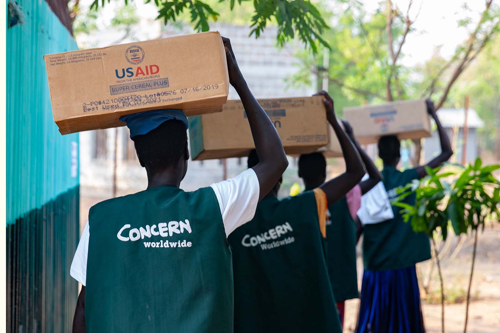 Concern staff carrying nutrition supplies in Ethiopia