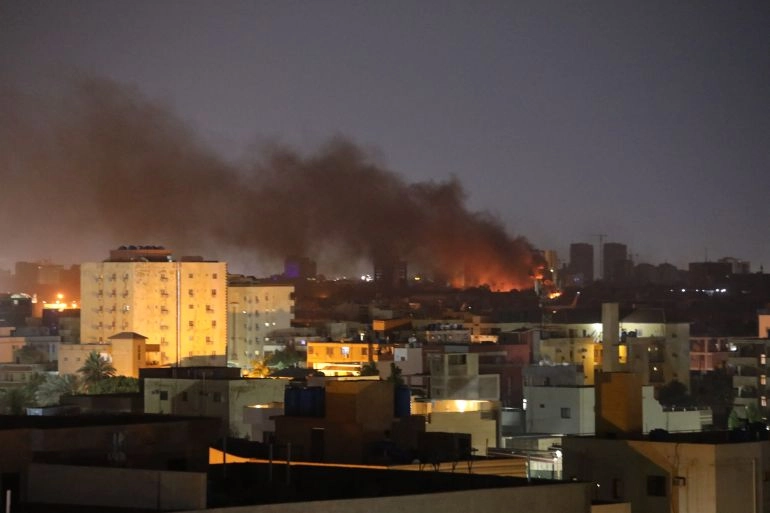 The Sudanese capital of Khartoum at night with smoke.