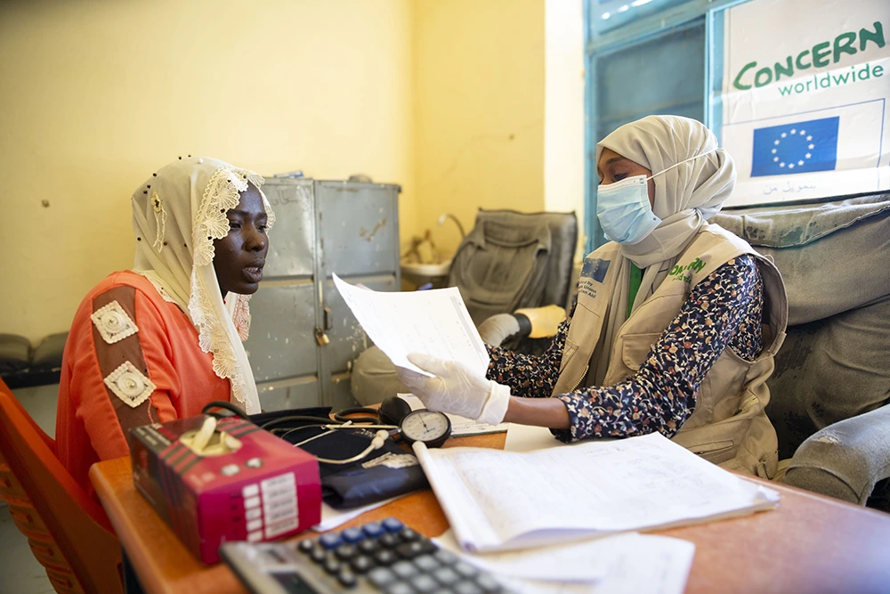 A Concern doctor consults with a patient in Central Darfur, Sudan