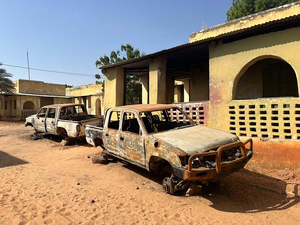 A burnt-out vehicle near a health center in West Darfur
