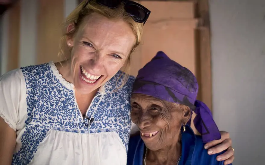 Toni Collette with Carmen Pierre during a visit to Saut d’Eau in Haiti