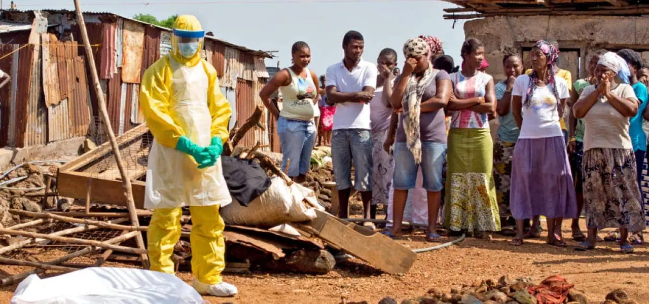 People pray in Sierra Leone during an Ebola burial