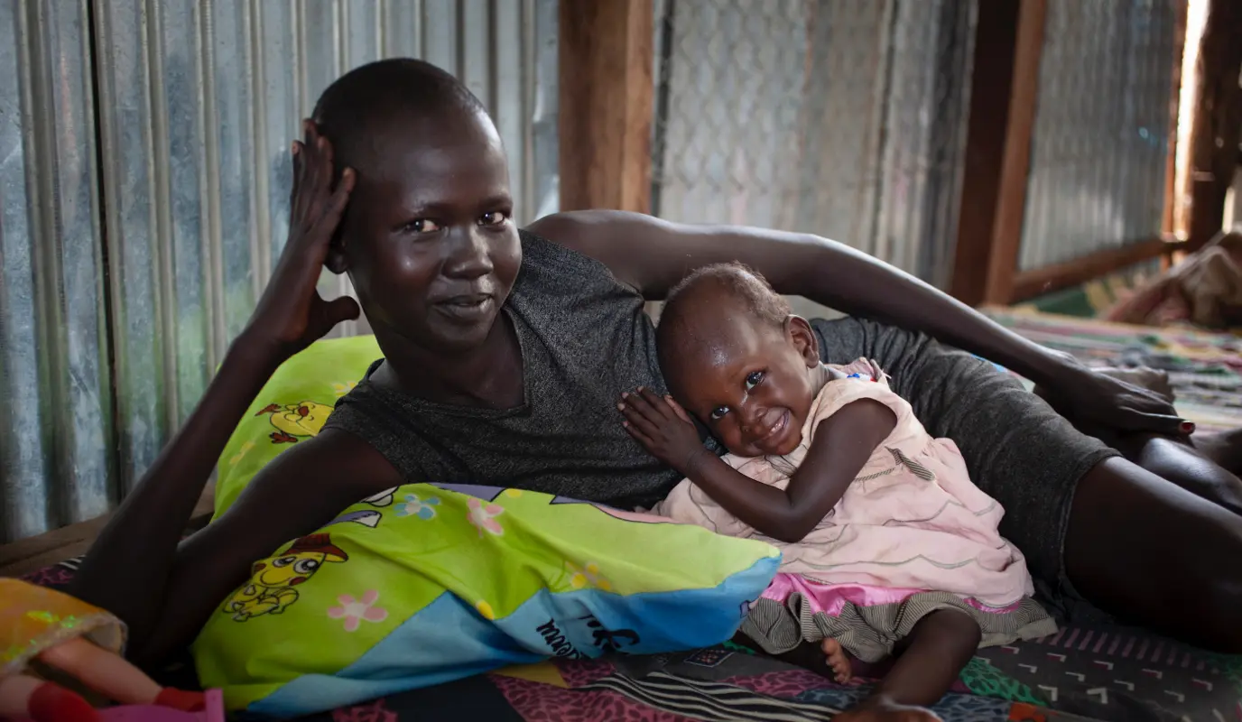 Woman and baby in the mother and baby room at the Concern Worldwide Nutrition Clinic in a POC in Juba, South Sudan.