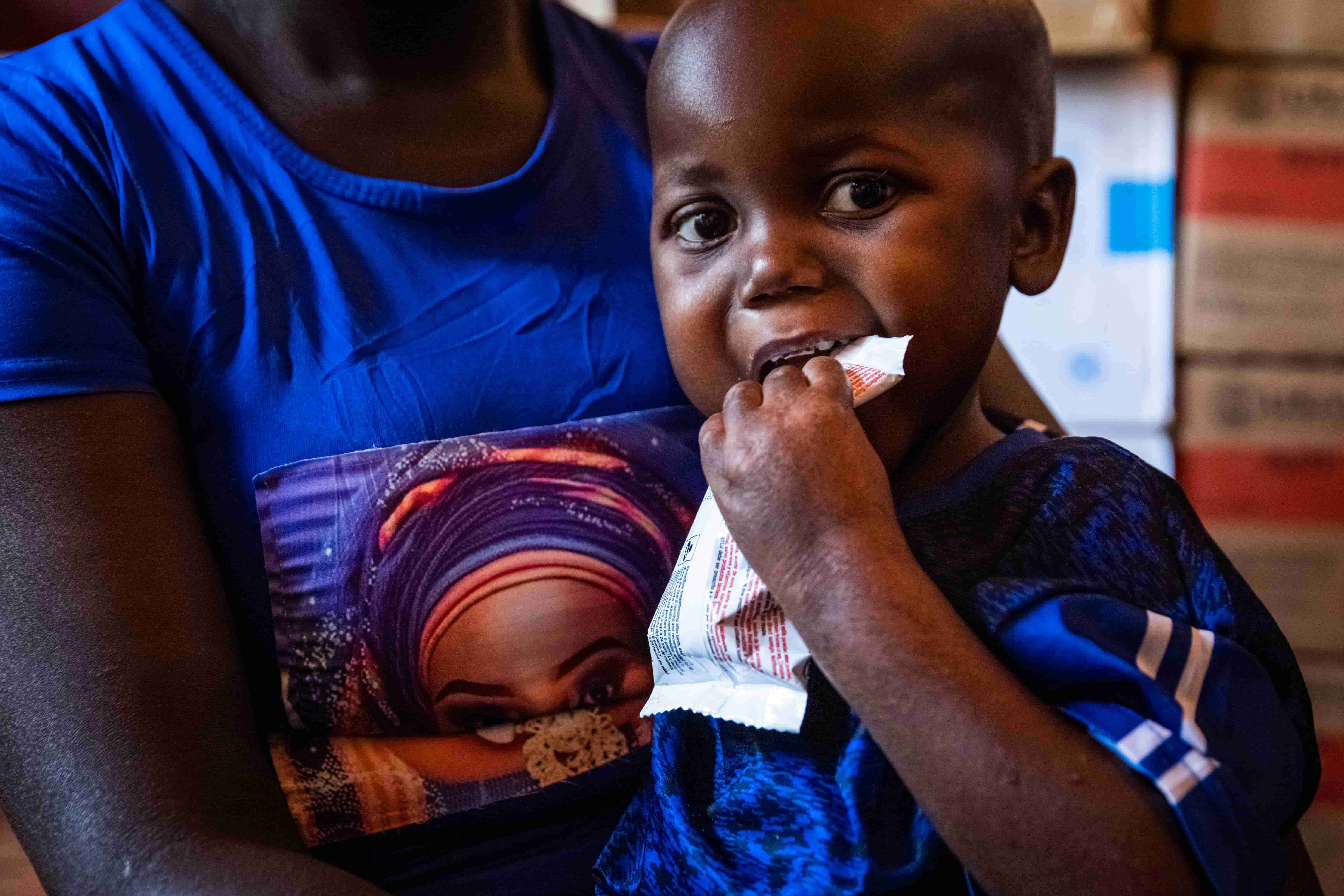 Infant eating therapeutic food to treat malnutrition