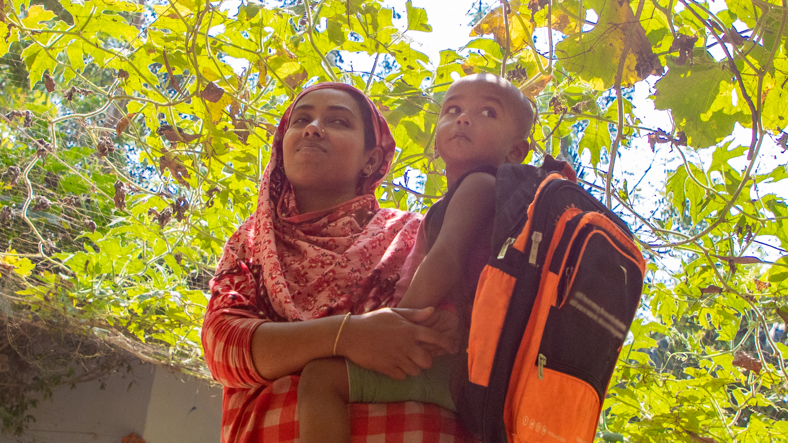 Hosenare Aktar (28) is a mother of 2. She has two sons Sakib (10) and Rakib (2) pictured. Before CRAAIN, Hosenare had never farmed before. Concern gave her training, seeds and goats. Now she has ducks, goats and an abundance of vegetables all because of Concern. She also employs a lot of climate smart agriculture like growing in bags and making compost and growing on elevated terraces. (Photo: Gavin Douglas/ Concern Worldwide)