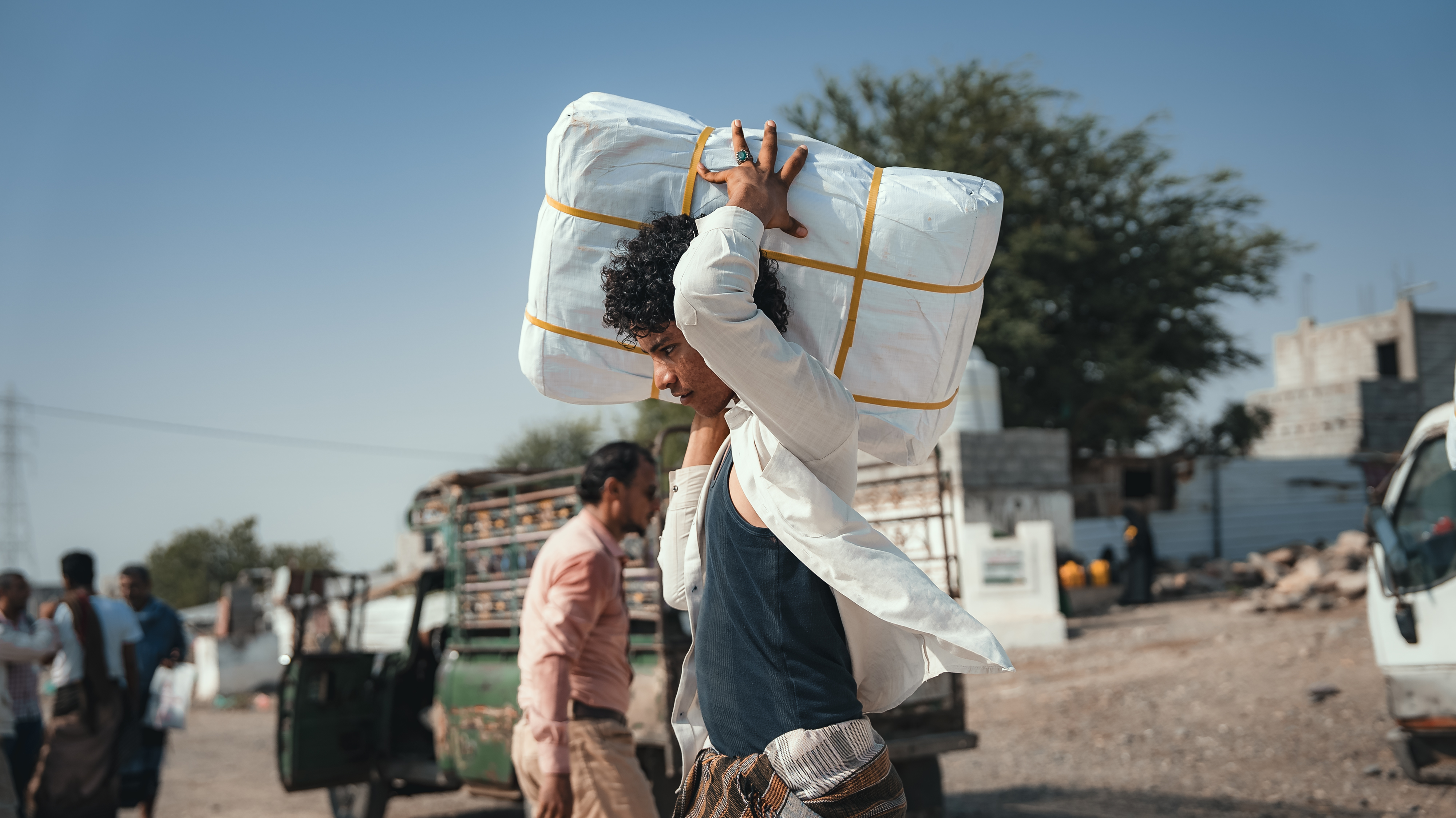 The Concern team distributing shelter materials to people affected by the sandstorm that struck Al Anad IDP Camp, Tuban District, Yemen. Photo: Ammar Khalaf/Concern Worldwide