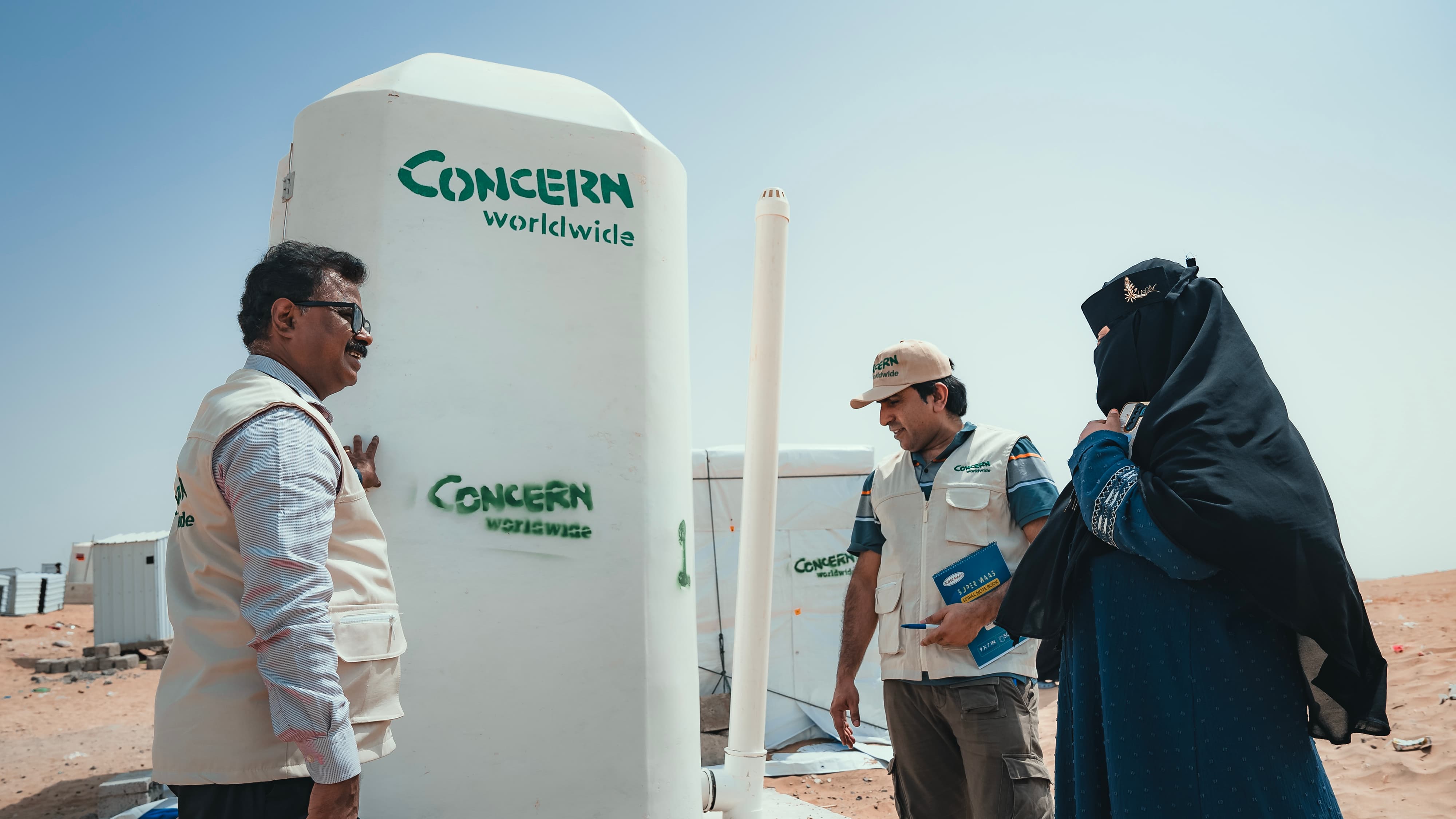 Concern Yemen Country Director Victor Moses, Programme Director Abdul Ghaffar and the Concern team distribute shelter materials, water and sanitation support to people affected by the sandstorm that struck Al Anad IDP Camp, Tuban District