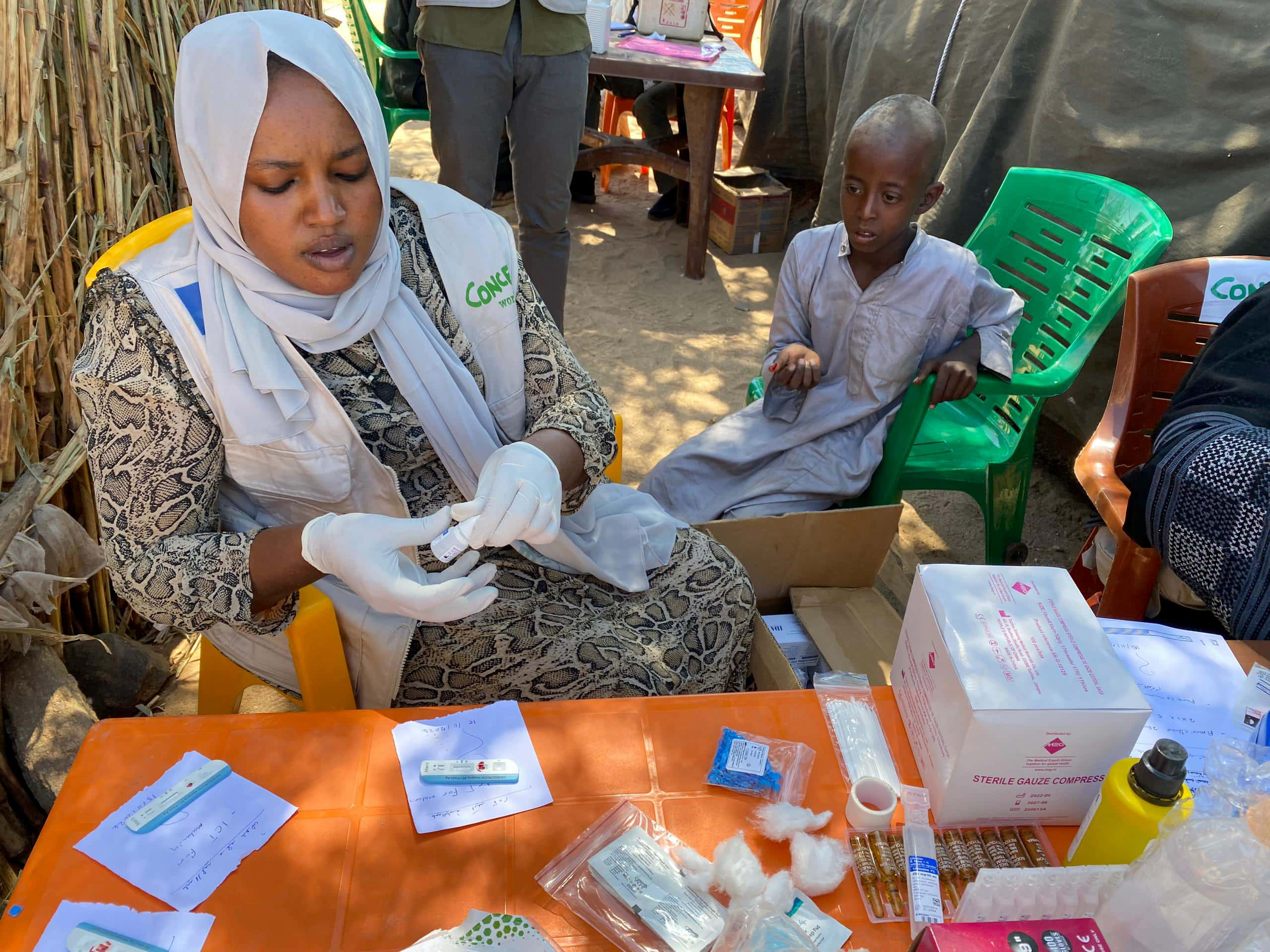 Concern ERM (Emergency Response Mechanism) team reach remote communities in Um Shalaya refugee camp in Central Darfur. Adam Mohammed Hasan (8) receives a check up from a Concern ERM team member. Photo: Concern Worldwide