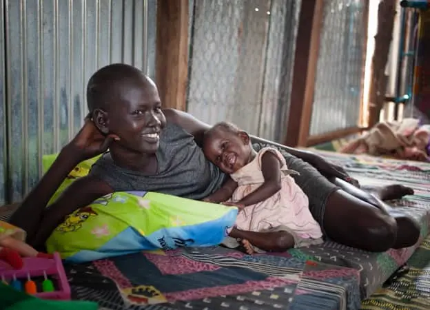 Mother and child in the mother and baby room at the Concern Worldwide Nutrition Clinic in a POC in Juba, South Sudan
