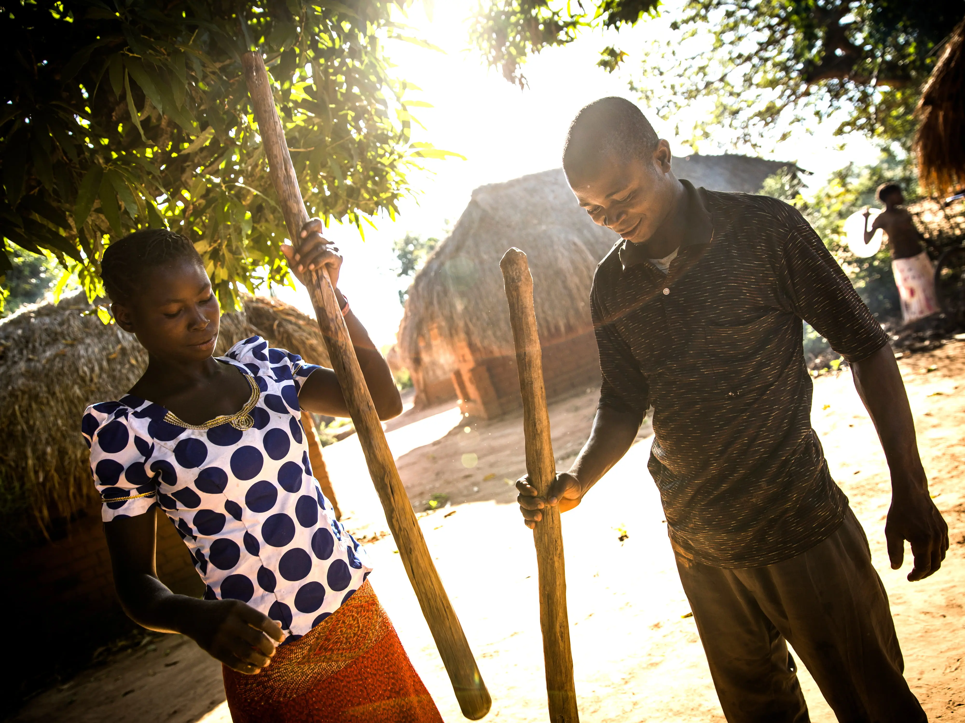 George Mukaly Ngoyi, 31, and Natalie Ngoyi, 20, prepare cassava flour together in the town of Pension, Manono Territory.